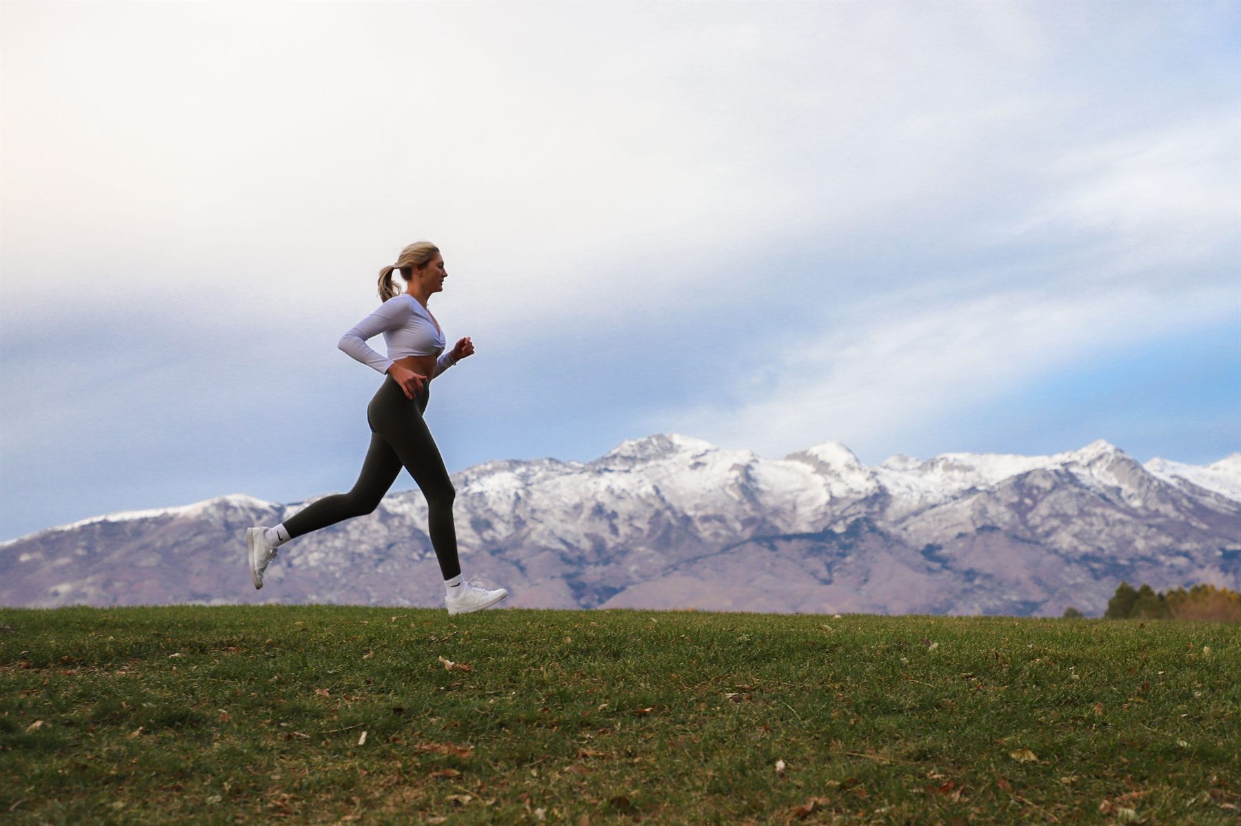 Kiera running with mountains behind her
